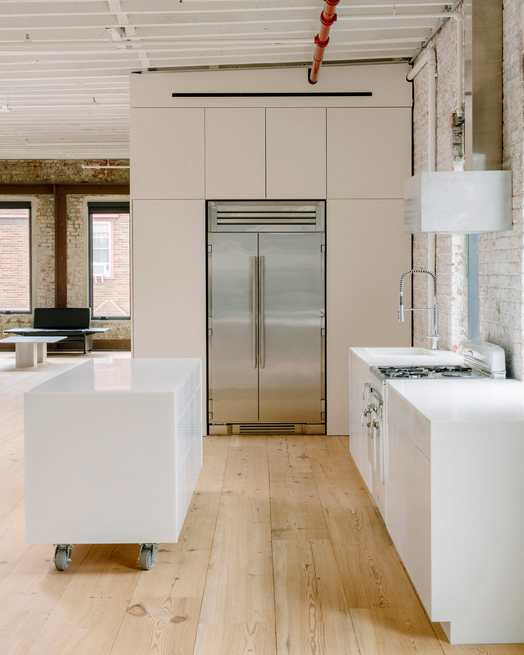 Modern white kitchen with stainless steel fridge